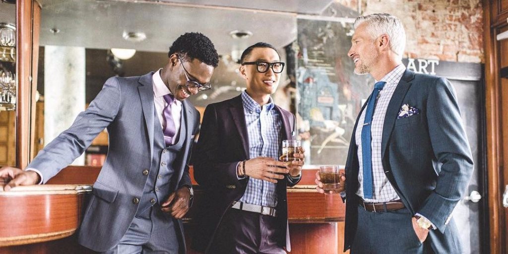 Men in suits gathered around a table
