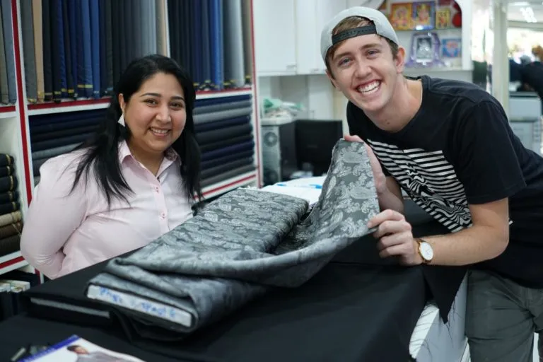 Dave and Pinky discussing what to ask before ordering a custom suit in Bangkok with a customer