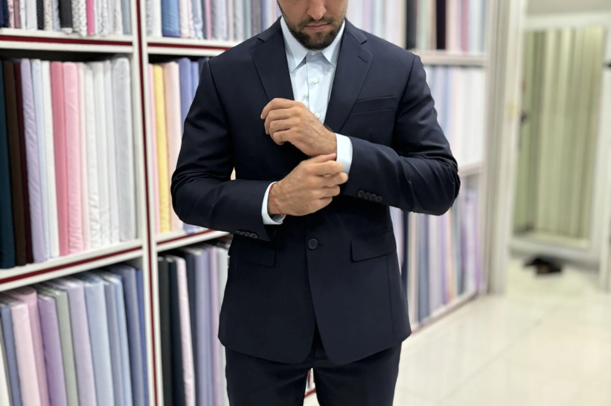 Front, side and back views showing how to judge the quality of a tailored suit during a fitting in Bangkok