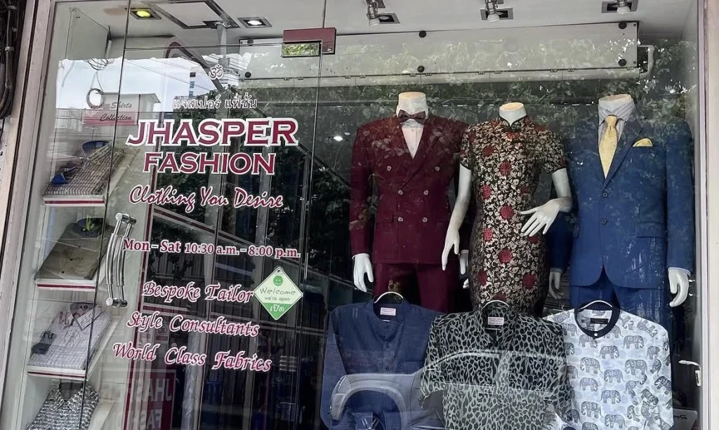 Jhasper Fashion shopfront with a glass entrance, branded signage and mannequins displaying suits.